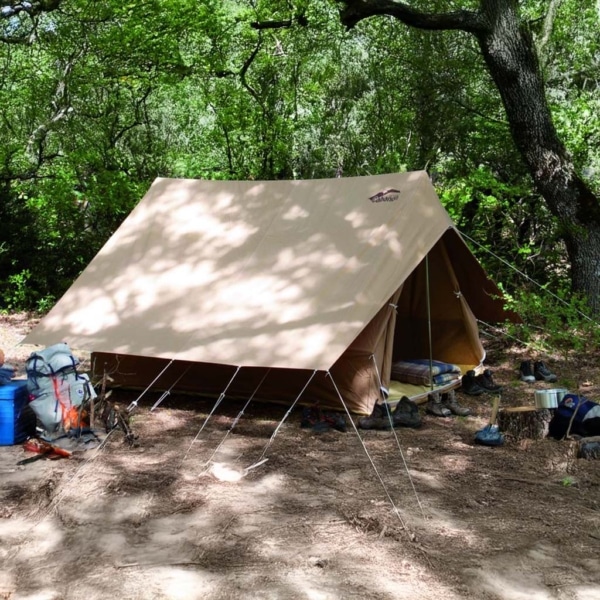 Patrouille tent pitched in a forest setting.