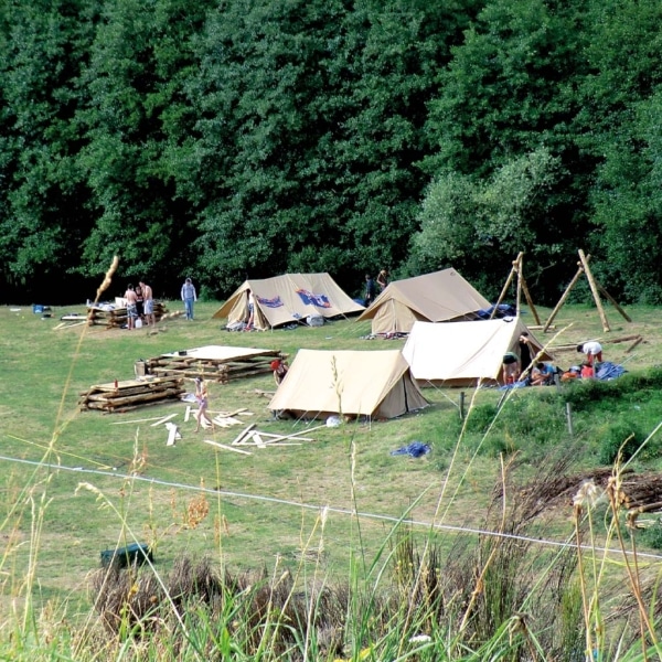 Patrouille tent pitched in a forest setting.