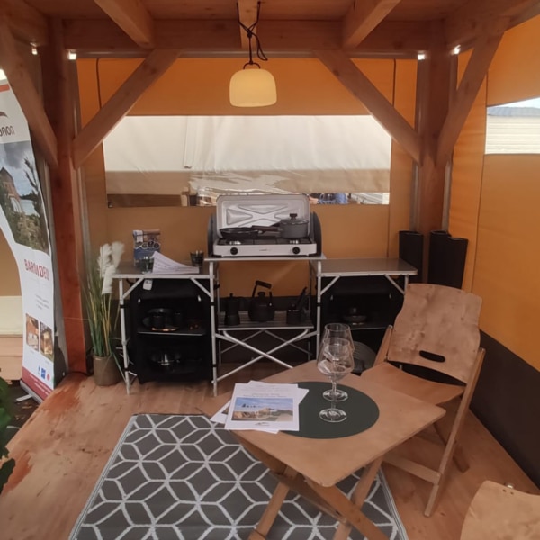 Baroudeur 2 tent with elevated living space and durable wood structure.